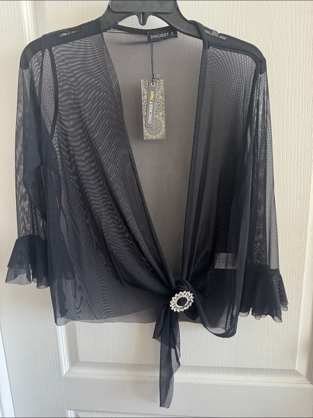 Women’s black sheer mesh tie-front shrug with rhinestone buckle and bell sleeves